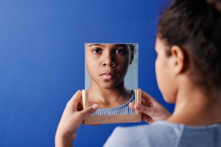 Child looking in a mirror