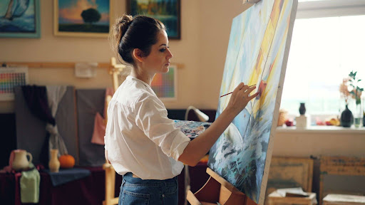 woman painting on a canvas