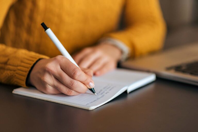 Someone writing in a journal