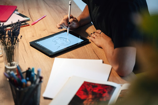 someone drawing on an ipad