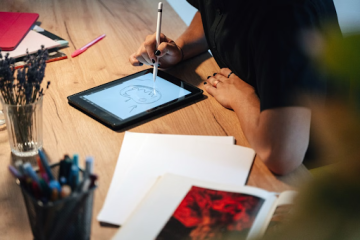someone drawing on an ipad