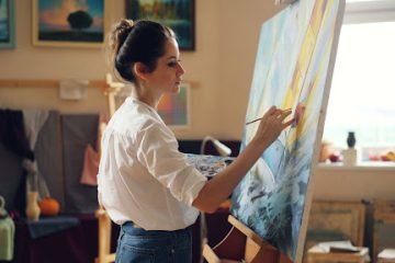 woman painting on a canvas